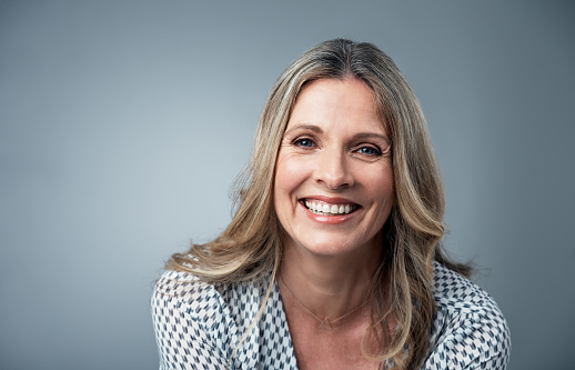 A woman with a bright, white smile after getting professional teeth whitening treatment at A Smiling Heart Dentistry in Bellevue, WA