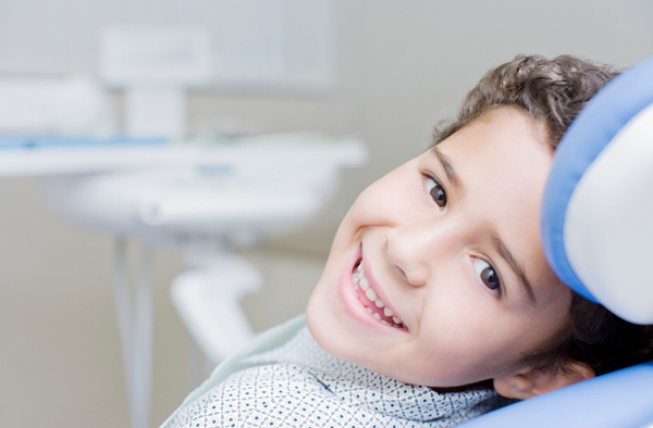 Young boy smiling with healthy teeth after getting dental sealants at A Smiling Heart Dentistry in Bellevue, WA